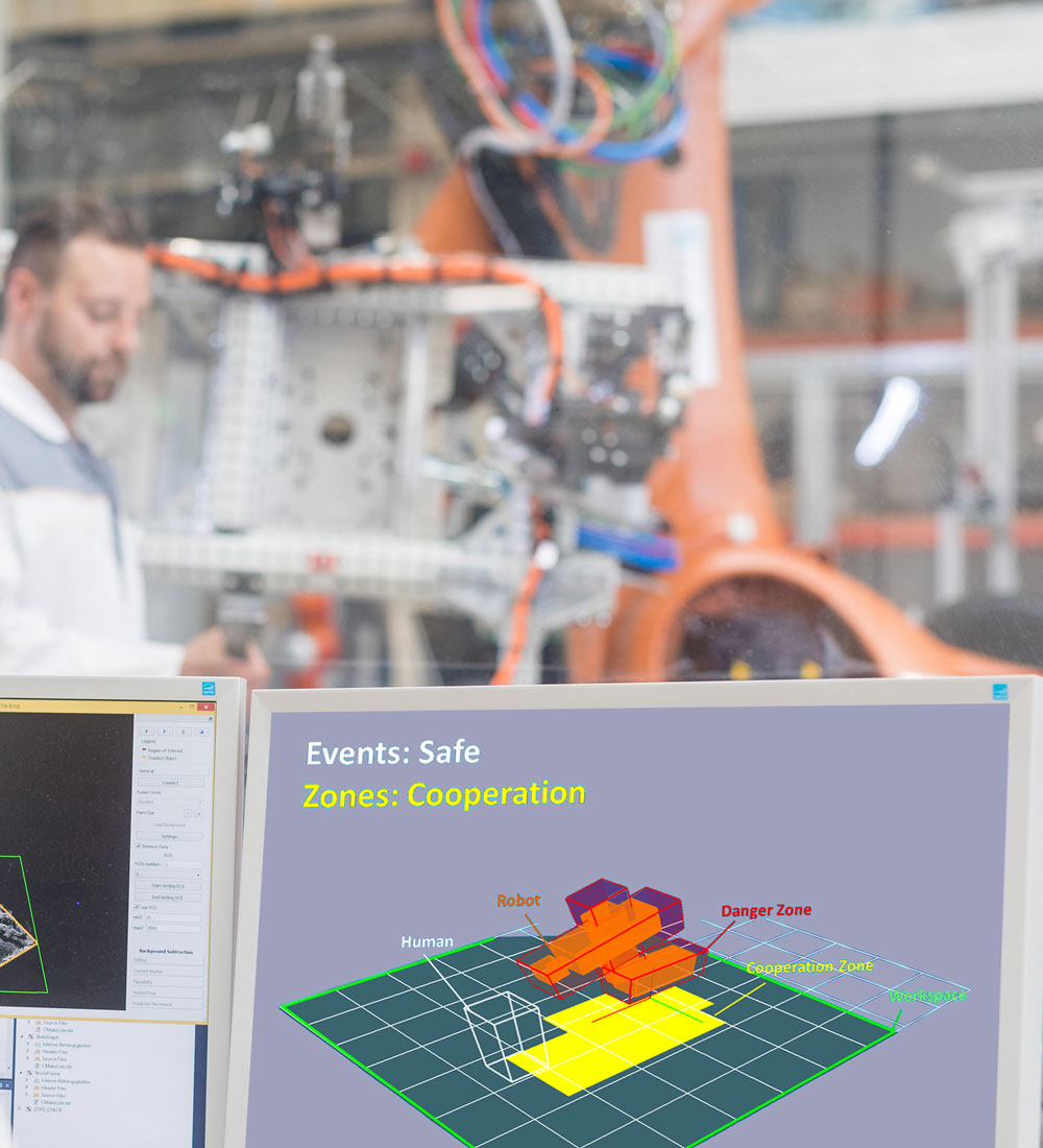 Various safety zones around the robot determine wether and how robot and human can work together in each zone.